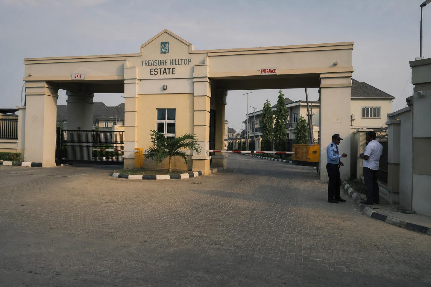 Gated Nigerian estate entrance with security post